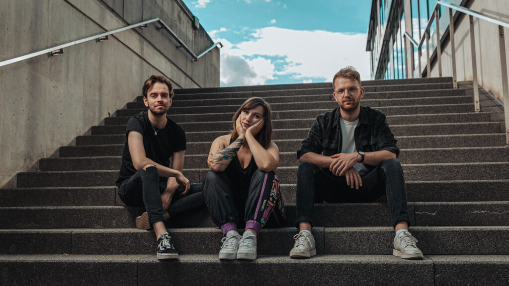 HeyMiracle Die Band Hey Miracle sitzt auf einer Treppe